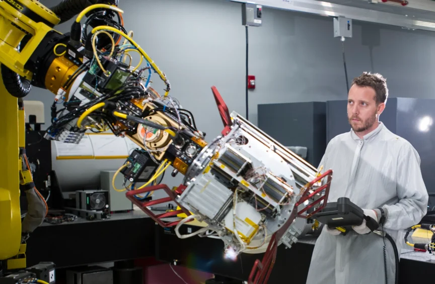 A man who works for Raytheon looking at a large machine