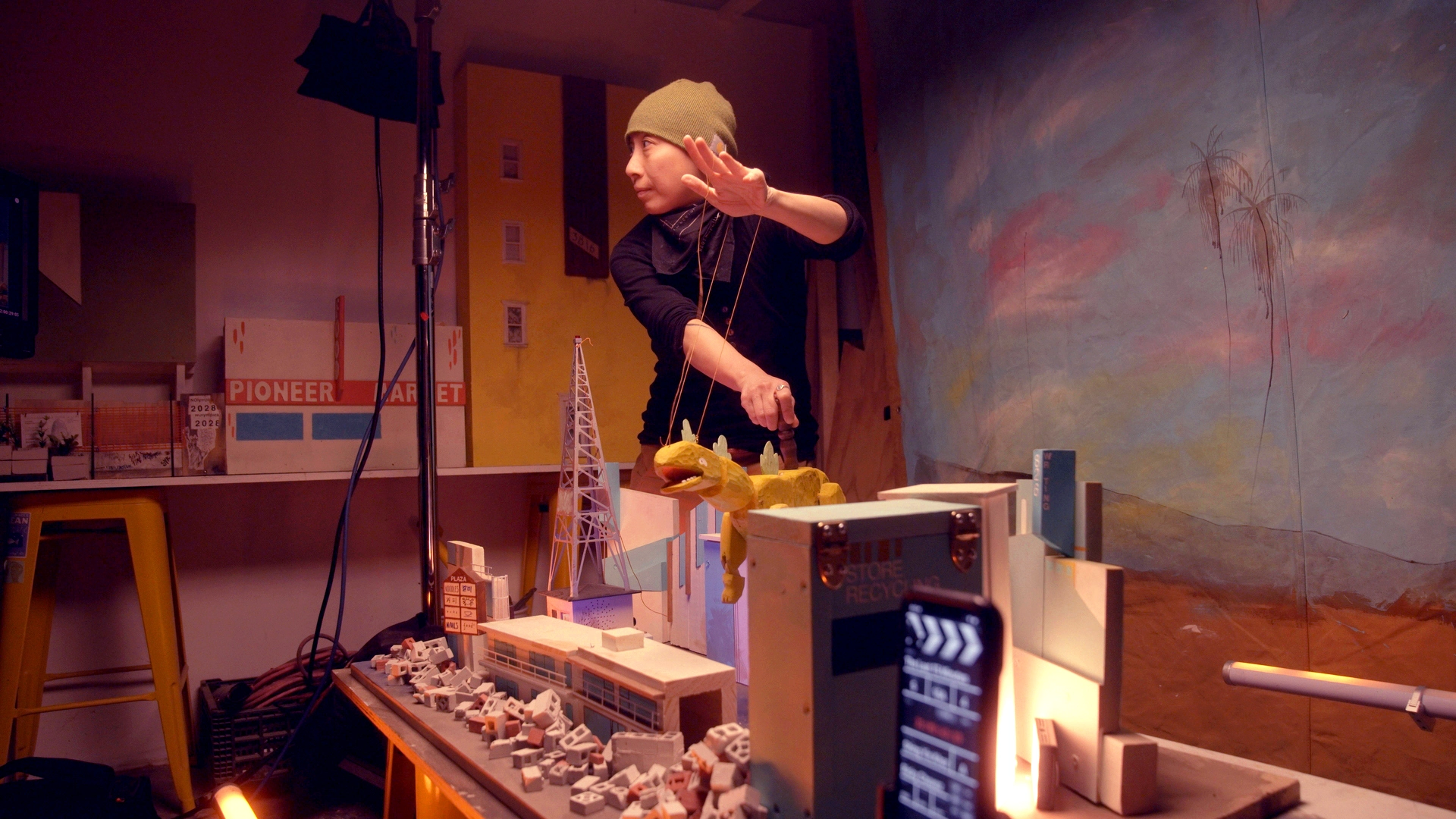 Shing Yin Khor puppets the Kaiju tabletop puppet on-set.
