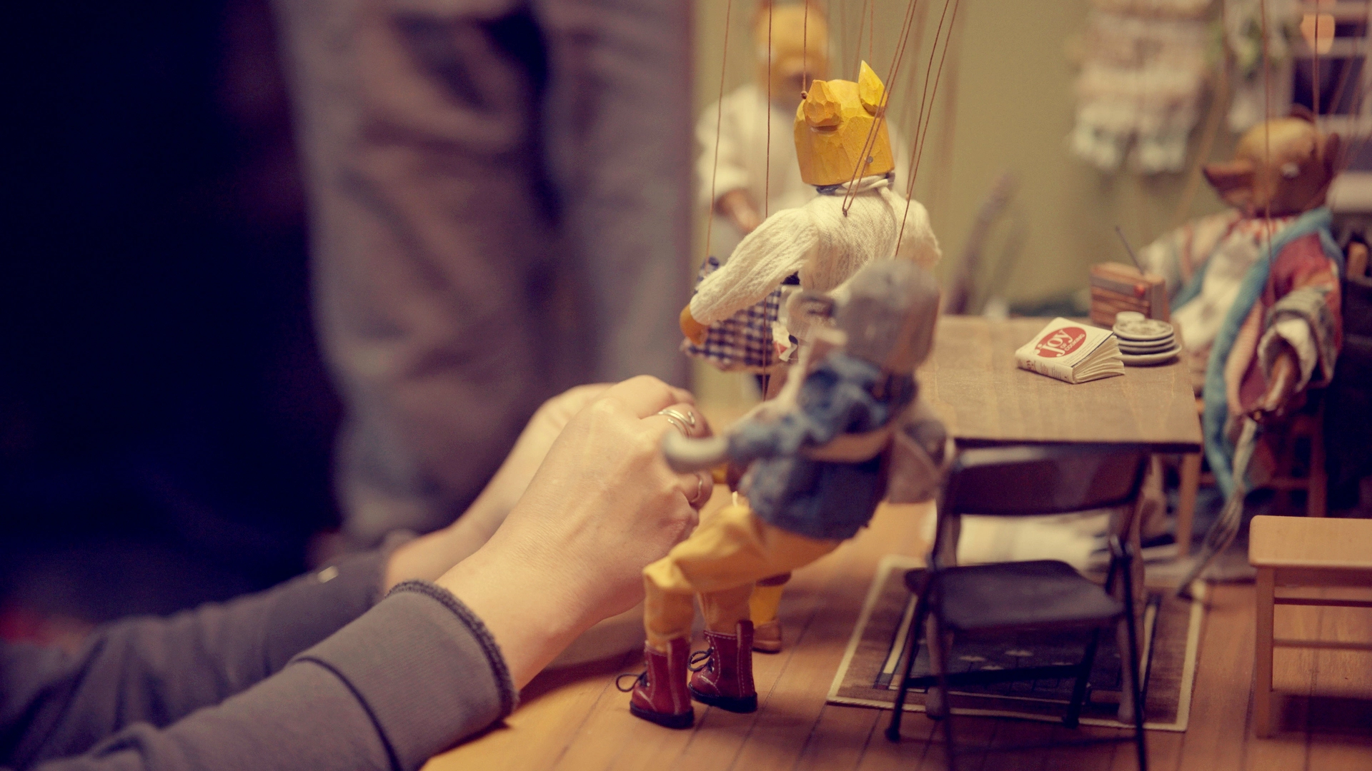 BTS documentary still from The Last Fifteen Minutes. Molly Painter does last minute puppet fixes.