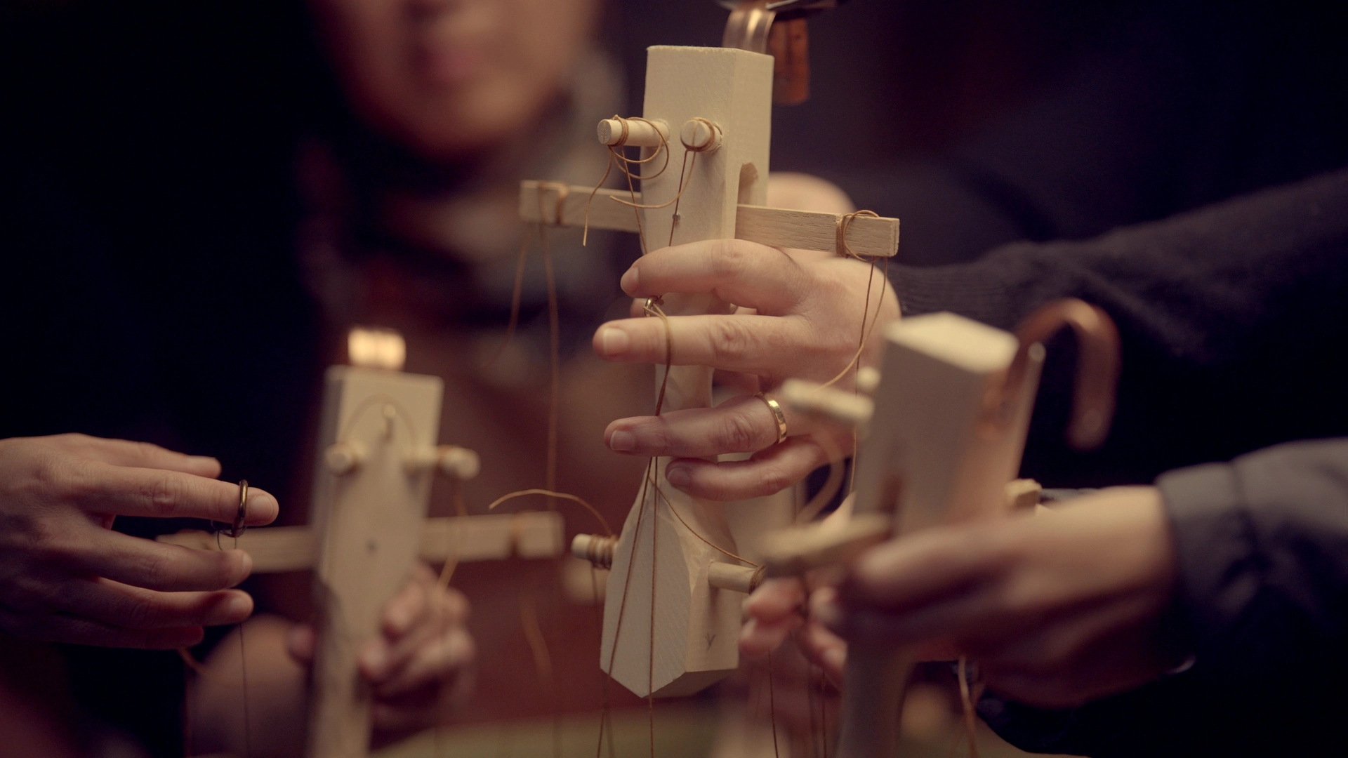 BTS documentary still from The Last Fifteen Minutes. The puppeteers and marionette controllers.