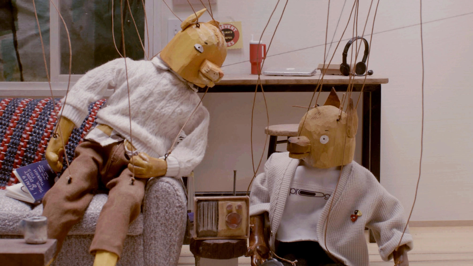 Still from The Last Fifteen Minutes. Robin and Paulo listen to the emergency alert.