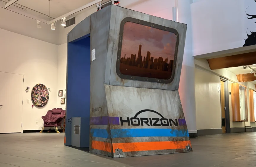 A large grey booth reads “HORIZON” and a window shows a faux reflection of a flooding NYC.