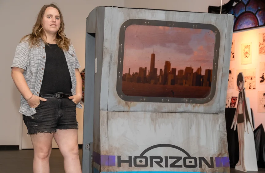 An image of Skye standing next to the arcade booth.