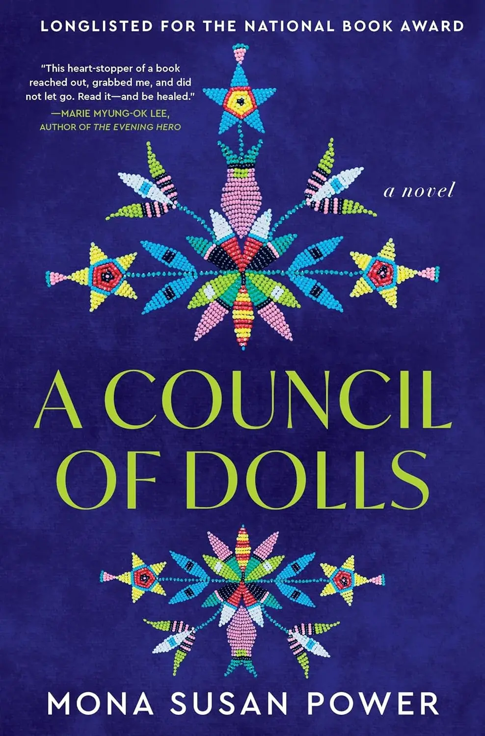 A dense, radiating beadwork medallion in turquoise, red, yellow, pink, and green sits against a deep navy cover, echoed by a smaller matching design below. The title 